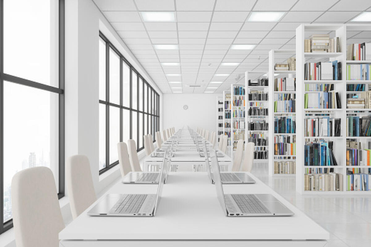 Scuole scomposte? Si, grazie!!! - Modern Library With Laptops On The Table And Books On The Bookshelves.