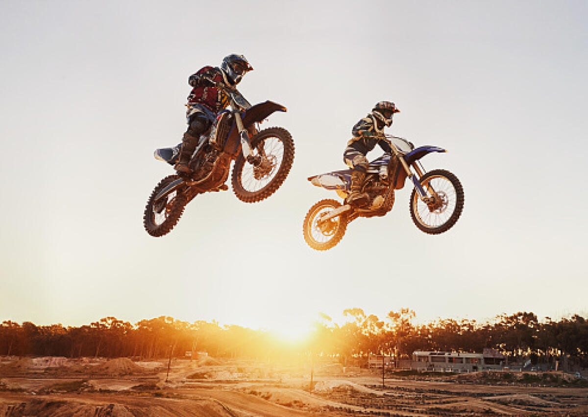 Enduro ,Sardegna junior sopra il tetto del mondo? E invece NO - A shot of two motocross riders in midair during a race