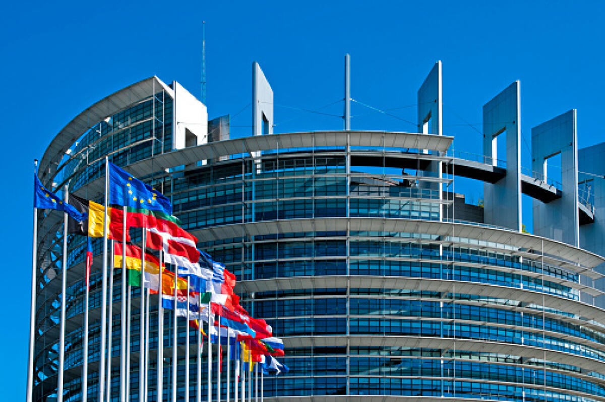 Iniziativa per la Giornata dell'Europa 2023 - The European Parliament building in Strasbourg, France with flags waving calmly celebrating peace of the Europe. July 12, 2020.