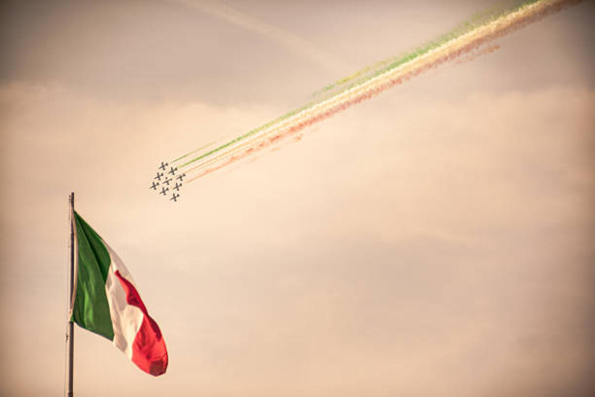 La bandiera che ci unisce: "il Tricolore e l’identità di popolo secondo il Presidente Mattarella” - Bari, Italy - November 4, 2011: The italian acrobatic jet squad named "frecce tricolori" do elaborate tricks in the sky during the National Unity and Armed Forces Day of 4 November 2011